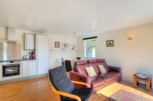 a living room with a couch and a table at Undercliff in Lyme Regis