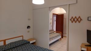 Postel nebo postele na pokoji v ubytování Hotel Oasi Ristorante Pizzeria