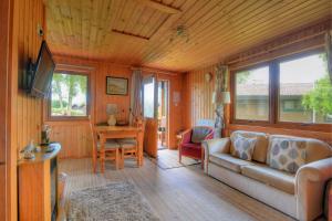 a living room with a couch and a table at 4 Pinewood Retreat in Lyme Regis