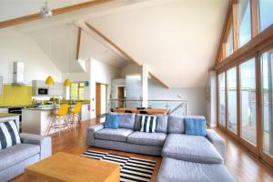 a living room with two couches and a table at Pippin in Charmouth