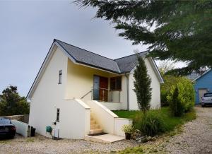 a white house with a staircase in front of it at Pippin in Charmouth