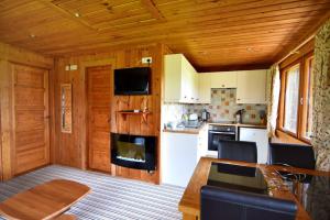 a kitchen and dining room with a table in a cabin at 10 Pinewood Retreat in Lyme Regis