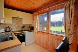 a kitchen with a sink and a window at 10 Pinewood Retreat in Lyme Regis