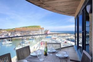 a table with chairs and a view of a marina at Venezuela in West Bay