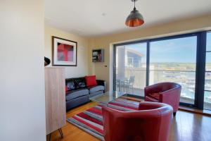 a living room with a couch and a glass table at Venezuela in West Bay