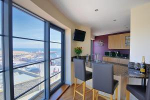 a kitchen with a counter and a large window at Venezuela in West Bay