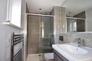 a bathroom with a shower and a sink and a toilet at Seas The Day in Lyme Regis +10 photos