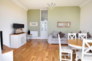 a living room with a couch and a table at Ocean View in Seaton