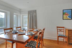Un comedor con mesa y sillas de madera. en Seashell, en Lyme Regis 8 fotos más