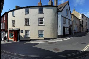 un antiguo edificio blanco en una calle de la ciudad en Driftwood, en Lyme Regis