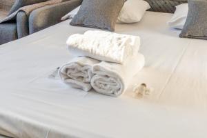 a pile of towels sitting on top of a bed at Nice studio with seaview in Deauville port - Welkeys in Deauville