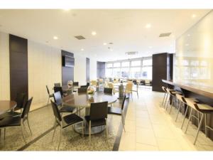 a dining room with tables and chairs in a building at R&B HOTEL HACHIOJI - Vacation STAY 38830v in Hachioji