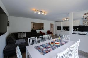 a kitchen and living room with a table and a couch at Haus Mosel in Klotten