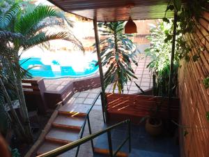 a view of a patio with a pool and plants at El Uru Suite Hotel in Puerto Iguazú