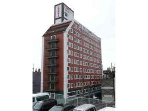 a red building with a sign on top of it at Rico Hotel Kokura - Vacation STAY 22584v in Kitakyushu