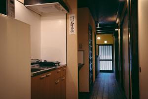 a kitchen with a sink and a hallway leading into a room at Kyoto Machiya Tabijuku Kotoon - Vacation STAY 30119v in Kyoto