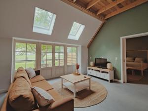 a living room with a couch and a table at B&B Wijdzicht in Wolsum