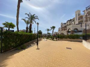 a sidewalk with palm trees and a street light at Casa Bellavista del Mar in Vera