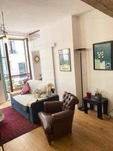 a living room with a couch and a chair at Beautiful appartment in the heart of Paris in Paris