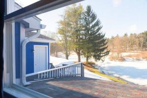 a window of a house with a blue door at GORGEOUS Poconos Springtime by the Lake! in Henryville