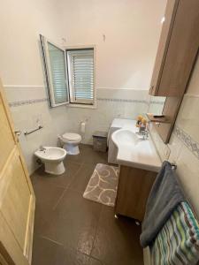 a bathroom with a sink and a toilet in it at Stella marina 2 da Alessandro in La Caletta +6 photos