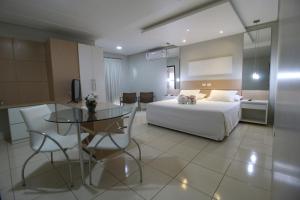 a hotel room with a bed and a table at Marruá Hotel in Bonito