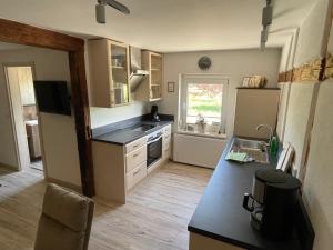 a kitchen with a sink and a counter top at Ferienwohnung Holzwurm in Wienrode +3 photos