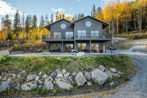 a house on a hill with rocks at Villabranten! Ski In - Ski Out, Bike In - Bike Out in Järvsö
