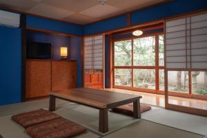 a living room with a wooden table and a window at WABI - Vacation STAY 52963v in Kanazawa