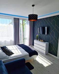 A bed or beds in a room at Apartament Golden Loft Studio Mielno - 100m od plaży