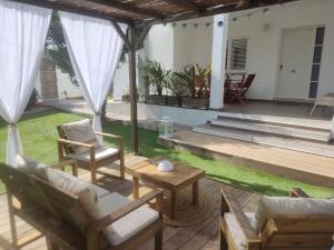a patio with chairs and a table and a house at Can mark in Nuestra Señora de Jesus