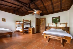 a bedroom with two beds and a ceiling fan at Rancho Margot Sustainable & Self Sufficient Eco Lodge in El Castillo de La Fortuna +49 photos