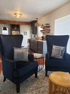 two blue chairs sitting in a kitchen with a table at Cute Cottage-2 min from downtown Lincoln in Lincoln