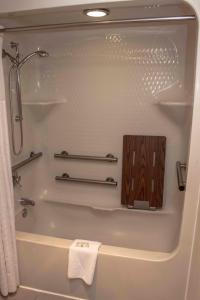 a bathroom with a shower and a bath tub at Quality Suites Lake Wright Norfolk Airport in Norfolk
