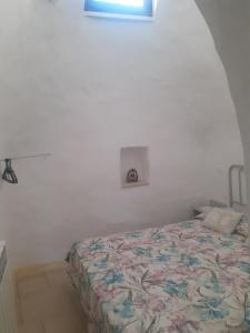 A bed or beds in a room at Trulli nonna Grazia-Aurora