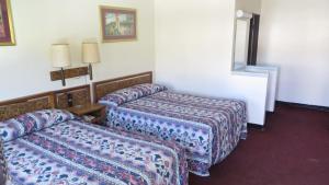 a hotel room with two beds and a window at Eagle Rock Motel in Los Angeles