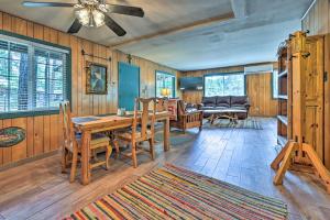 a dining room with a wooden table and chairs at Near Hiking Trails Woodsy Pine Cabin with Fire Pit in Pine