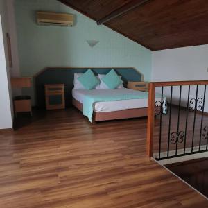 a bedroom with a bed and a wooden floor at Balkaya Hotel in Oludeniz