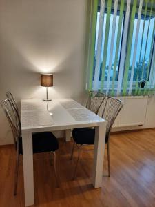 a white table with chairs and a lamp on it at Apartment Prague-2 rooms free parking in Prague