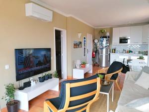 a living room with a couch and a tv at Sweden Apartment - Top Floor one bedroom with sea views - RS in Lagos