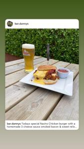 a plate with a sandwich and a beer on a table at Danny's Bar Restaurant & accommodation in Broadford