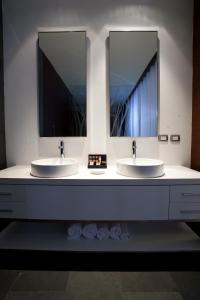 a bathroom with two sinks and a mirror at BTH Hotel – Boutique Concept in Lima