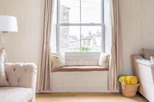 a window seat in a living room with a couch at Central Kendal Retreat - Work or Holiday friendly in Kendal