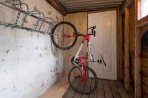 a bike is hanging on a wall in a room at Cosy 1st floor Flat - Kendal Lake District with bike storage in Kendal