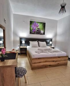 a bedroom with a large bed and a desk at MD APARTMENTS in Ulcinj