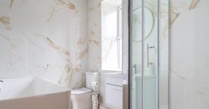 a bathroom with a shower and a toilet and a sink at Central Kendal Retreat - Work or Holiday friendly in Kendal