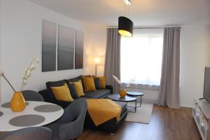 a living room with a couch and a table at Ferienwohnung Kassel West in Kassel