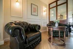 a living room with a leather chair and a table at Residenz am Ostufer in Boek