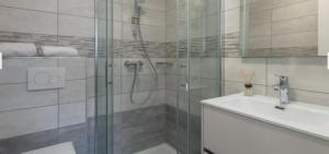 a bathroom with a glass shower and a sink at Sara in Rovinj +20 photos