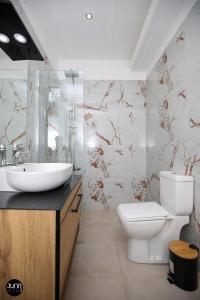 a bathroom with a sink and a toilet at Skyhill Rooms and Suites in Vlorë +61 photos